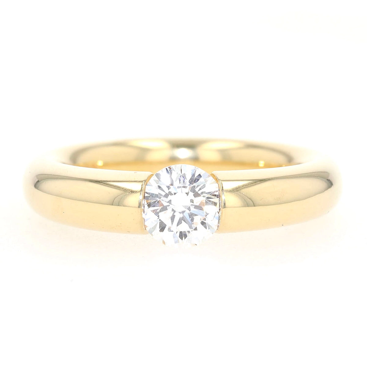 Niessing Spannring in 750er Gelbgold mit einem Brillanten ca. 1,0 ct, liegend frontal