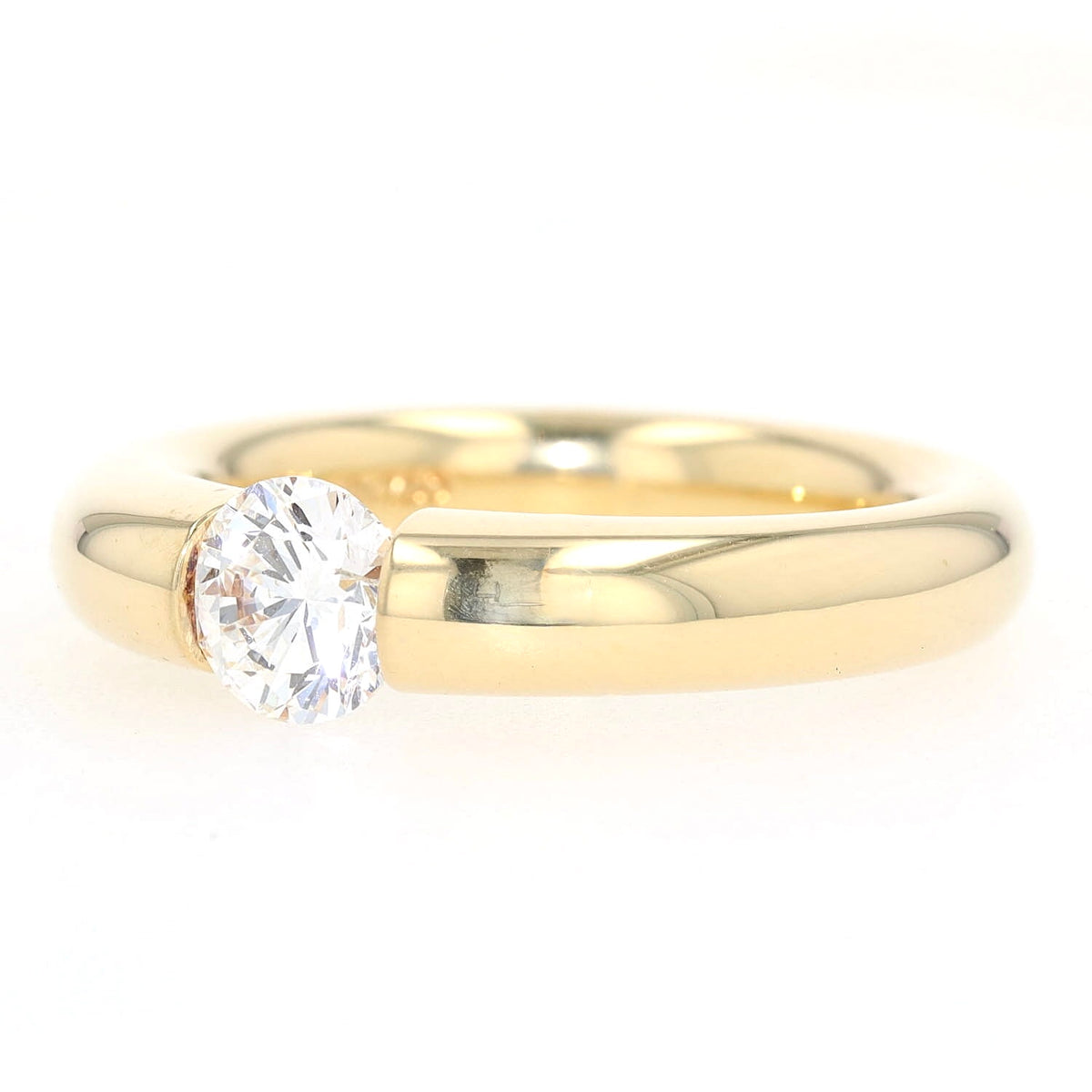 Niessing Spannring in 750er Gelbgold mit einem Brillanten ca. 1,0 ct, liegend links gedreht