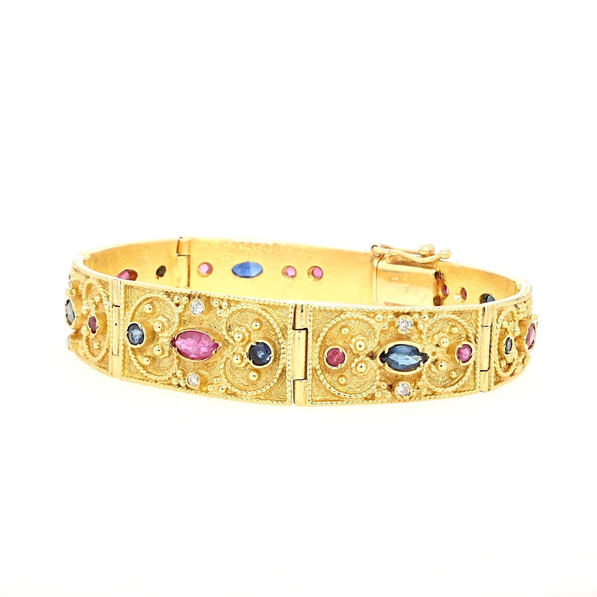 Armband in 750er Gelbgold mit Brillanten, Rubinen und blauen Saphiren, liegend geschlossen links gedreht