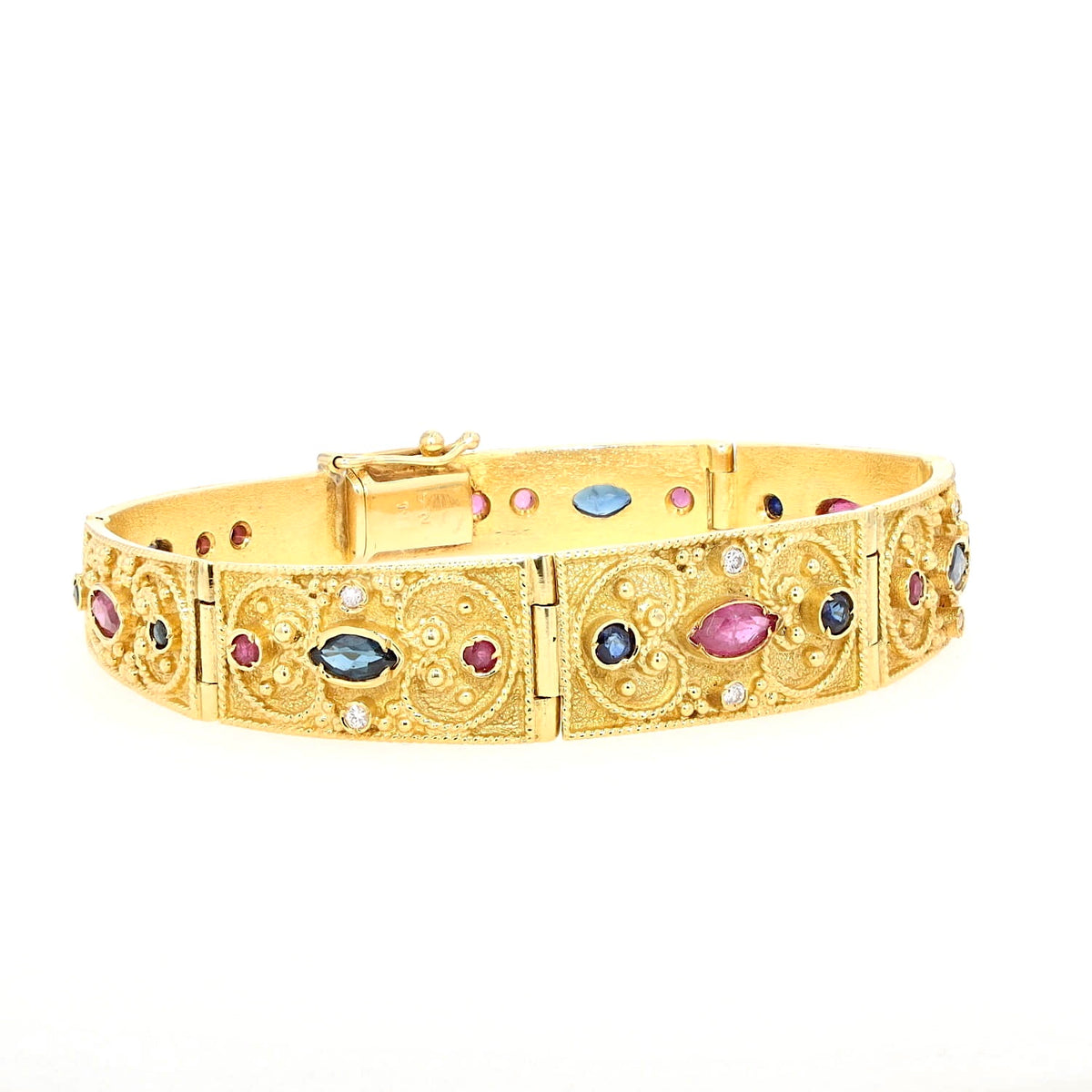 Armband in 750er Gelbgold mit Brillanten, Rubinen und blauen Saphiren, liegend geschlossen rechts gedreht