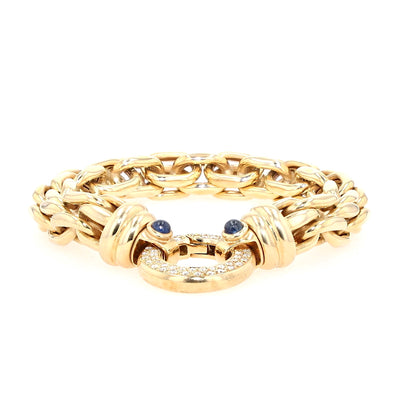 Peter Fischer - großes Gliederarmband von in 585er Gelbgold mit Brillanten und blauen Saphir-Cabochons, liegend frontal Schloss flach liegend