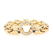 Peter Fischer - großes Gliederarmband von in 585er Gelbgold mit Brillanten und blauen Saphir-Cabochons, liegend frontal Schloss aufrecht