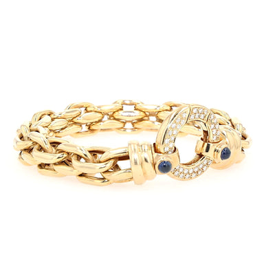 Peter Fischer - großes Gliederarmband von in 585er Gelbgold mit Brillanten und blauen Saphir-Cabochons, liegend rechts gedreht Schloss aufrecht